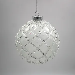 These Christmas ornaments are decorated with a grid pattern of glitter beads.