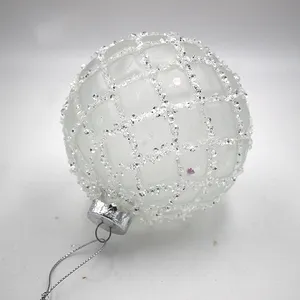 These Christmas ornaments are made of glass with a frosted finish and are decorated with glitter beads.